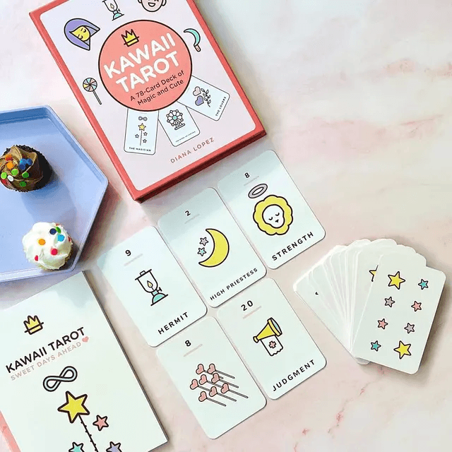 Kawaii Tarot deck, guidebook, and illustrated cards arranged on a pastel tabletop