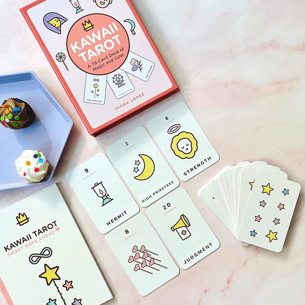 Kawaii Tarot deck, cards, and packaging arranged on a pastel tabletop